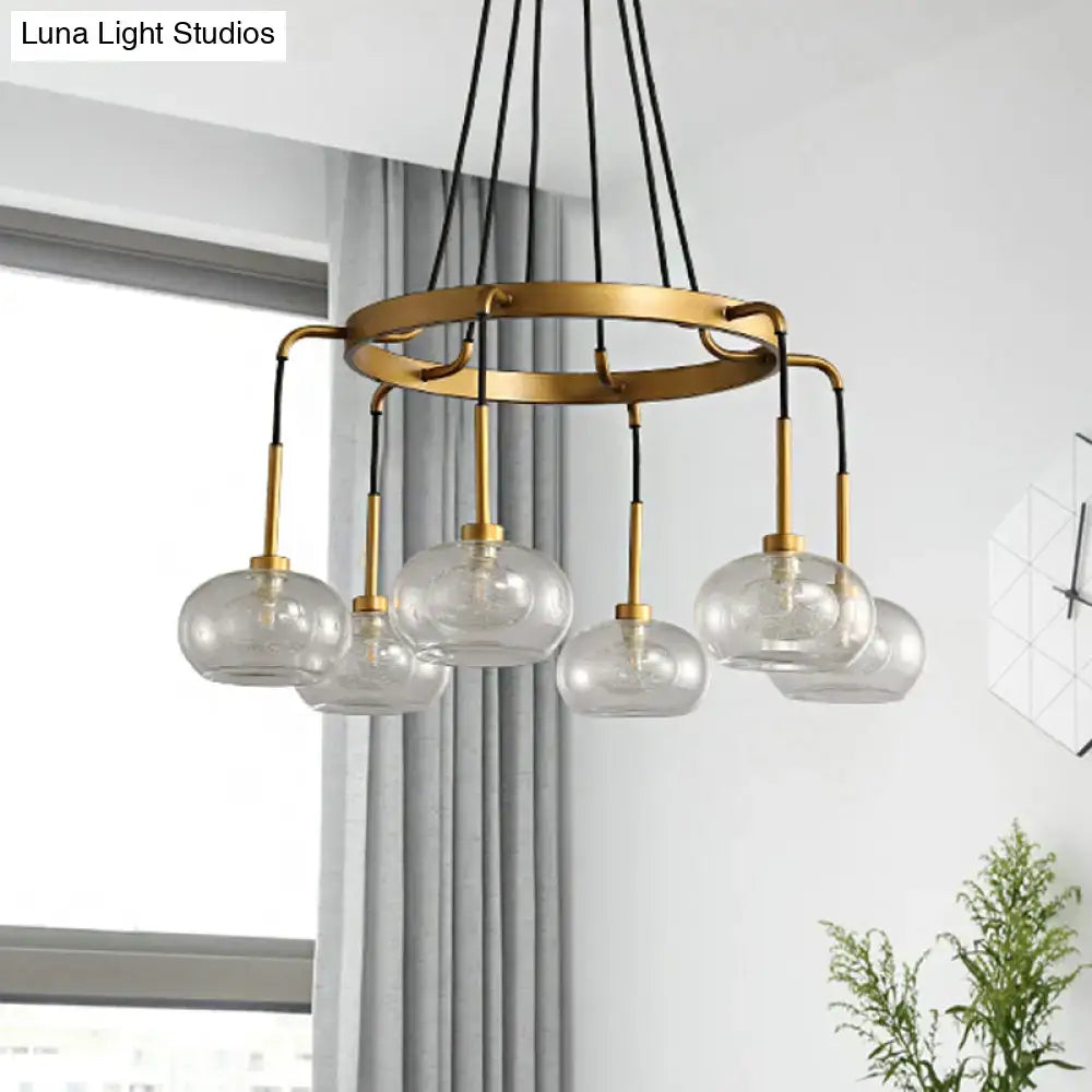 Modern brass-toned DecorBites™ post-modern island chandelier with five clear glass globe shades suspended by black cords