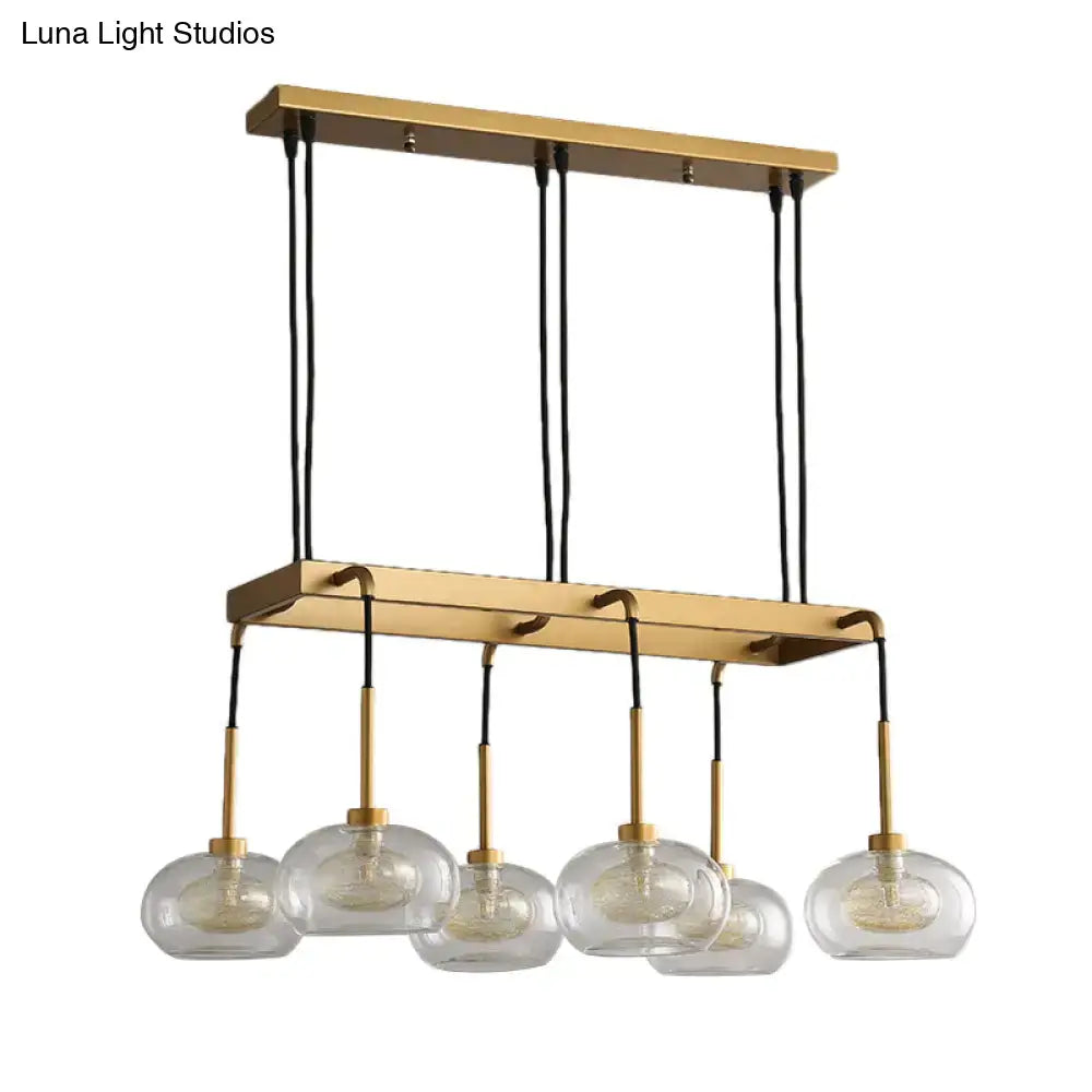 DecorBites post-modern island chandelier with gold finish and clear glass globe shades suspended by black cords