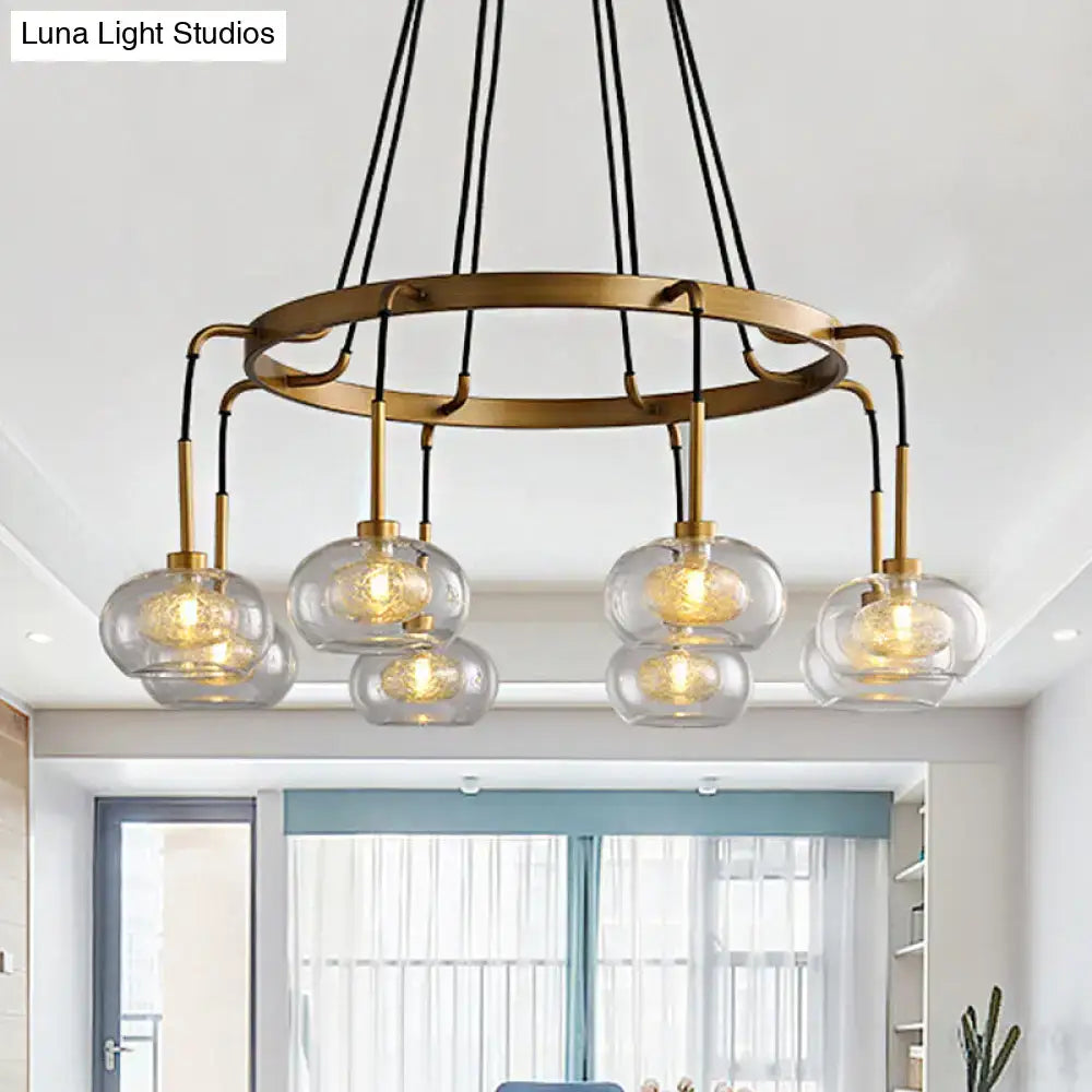 Decorbites post-modern island chandelier with brass tone, five clear glass globe shades, and black cords