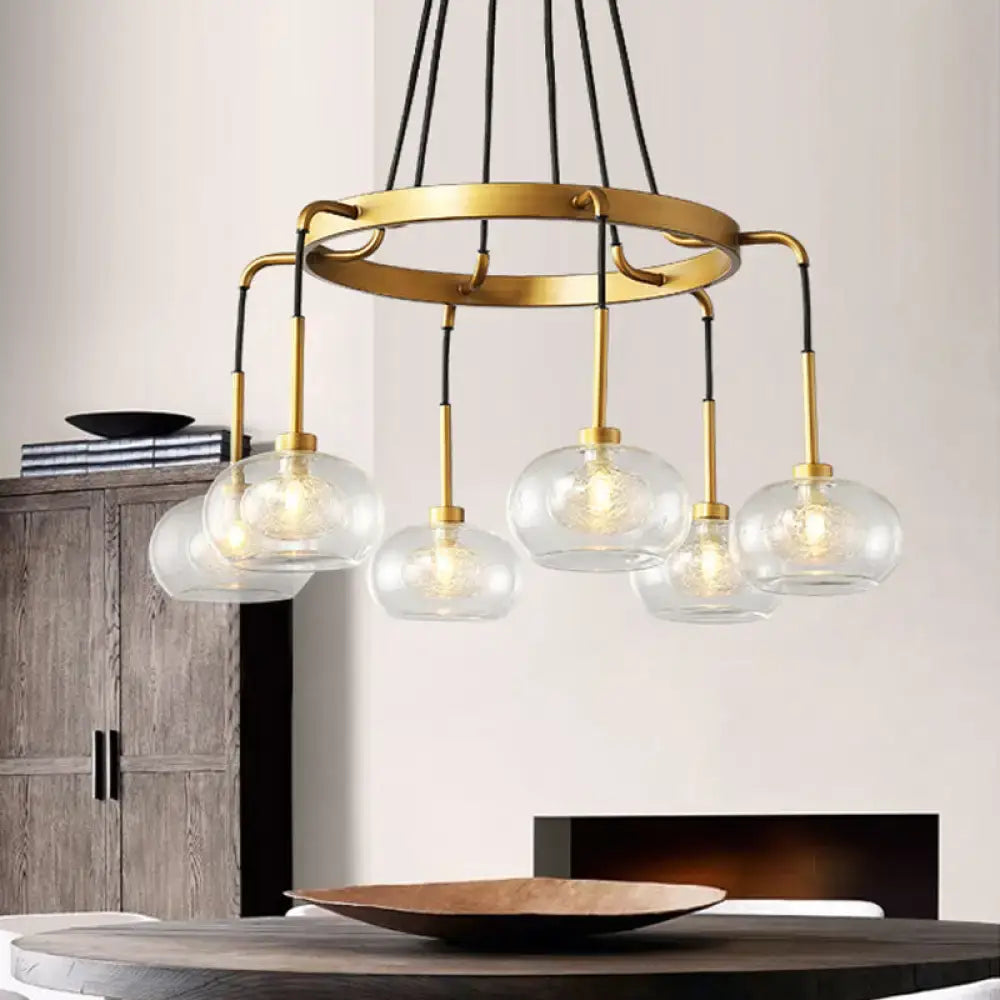 Gold-toned DecorBites™ post-modern island chandelier featuring clear glass globe shades and black cords with canopy options