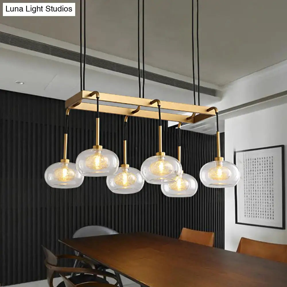 Modern brass rectangular chandelier with five clear glass globe pendants from decorbites post-modern collection