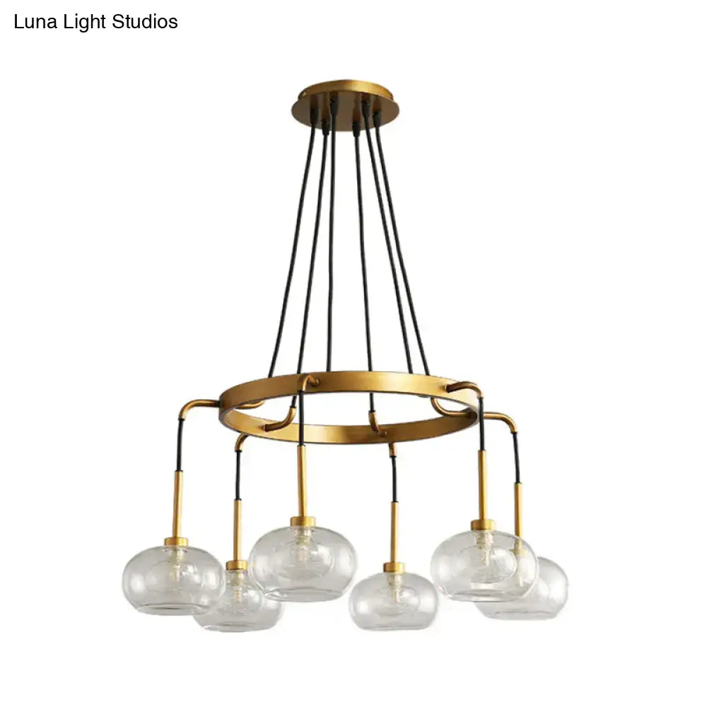 DecorBites post-modern island chandelier with gold finish, clear glass globes, black cords, and circular frame