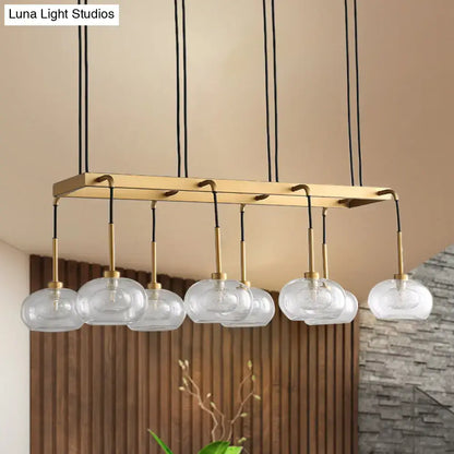 DecorBites post-modern island chandelier with clear glass globe pendants and brass rectangular frame suspended by black cords