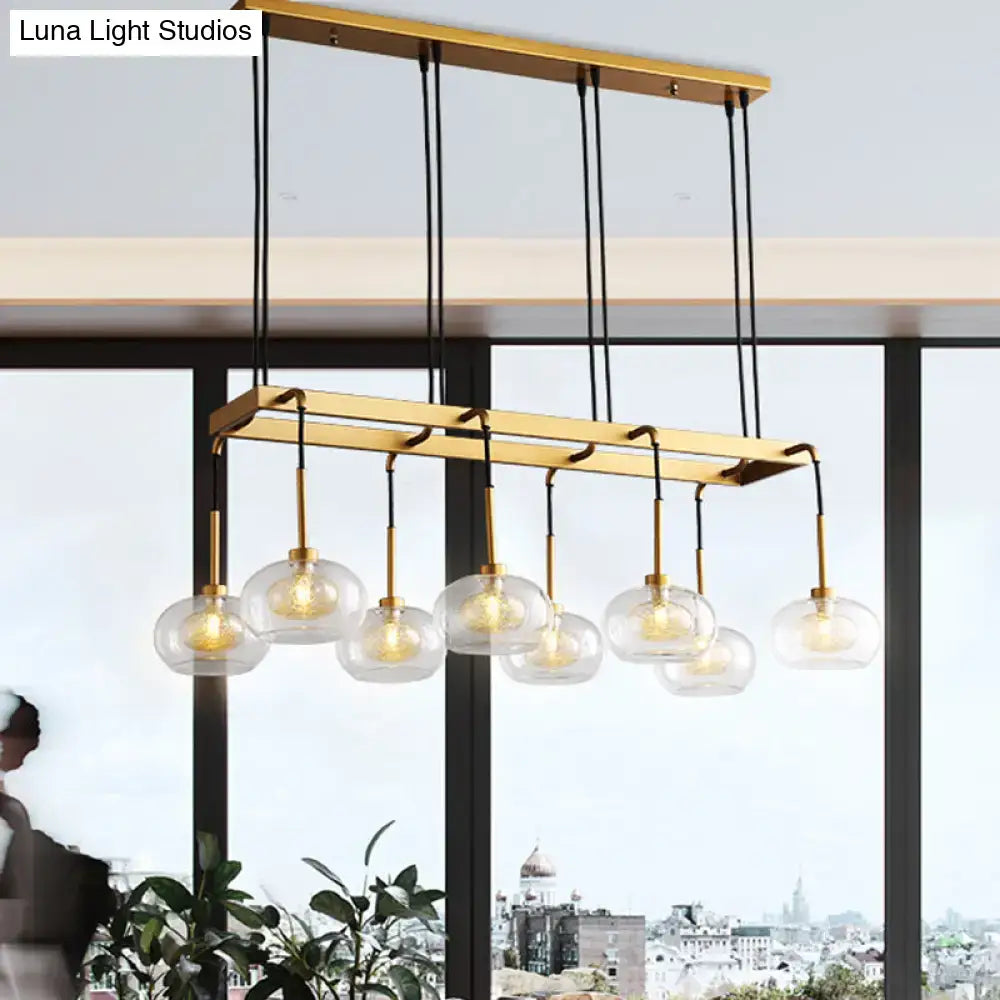 Gold-toned decorbites post-modern island chandelier with six clear glass globe shades and black cords