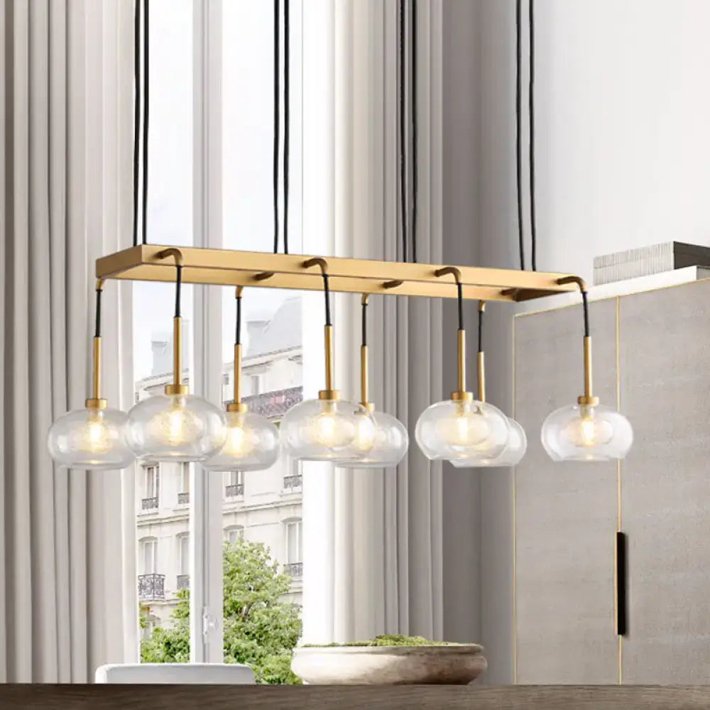 DecorBites post-modern island chandelier with clear glass globe shades brass finish and black cords suspension