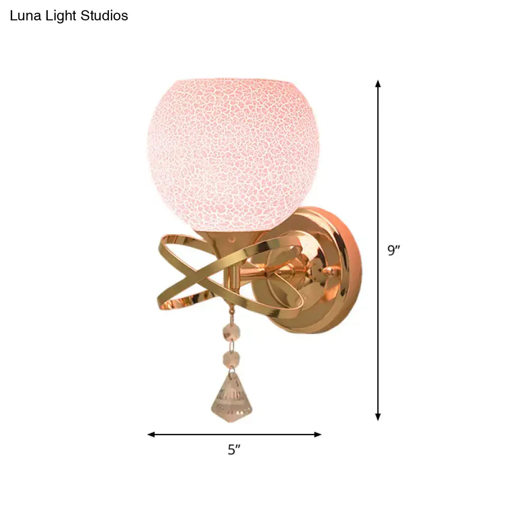 Delicate rose gold wall lamp with pink cracked glass globe and crystal teardrop light fixture for bedroom use