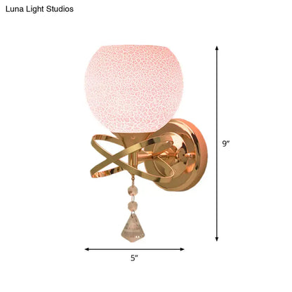 Delicate rose gold wall lamp with pink cracked glass globe and crystal teardrop light fixture for bedroom use