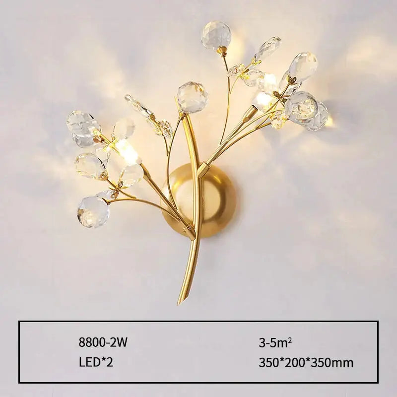 Post modern luxury gold wall sconce with crystal glass orbs in a modern luxury branch style for bedroom lighting