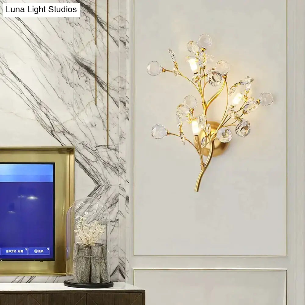 Post modern luxury gold crystal branch wall sconce featuring a gold-toned branching tree design for bedroom lighting