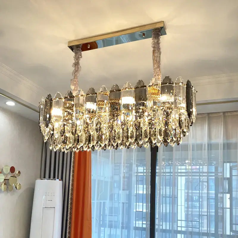 Post modern silver and brass decorbites crystal chandelier with cascading clear and smoky glass prisms for living room