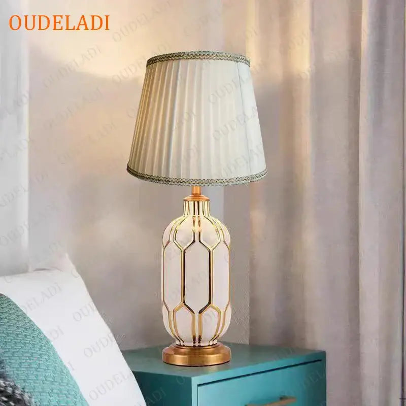 Elegant cream-colored ceramic table lamp with gold geometric accents and pleated shade by oudeladi for decorbites blue ceramic lighting