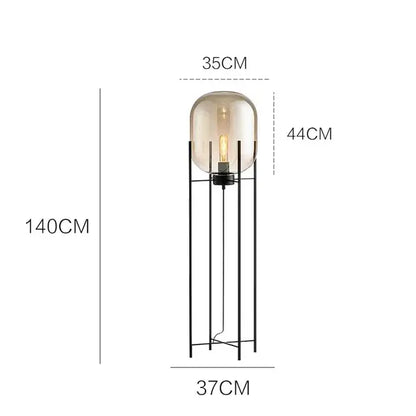Postmodern amber glass ball floor lamp with black metal frame and exposed filament bulb for living room decorbites glass ball