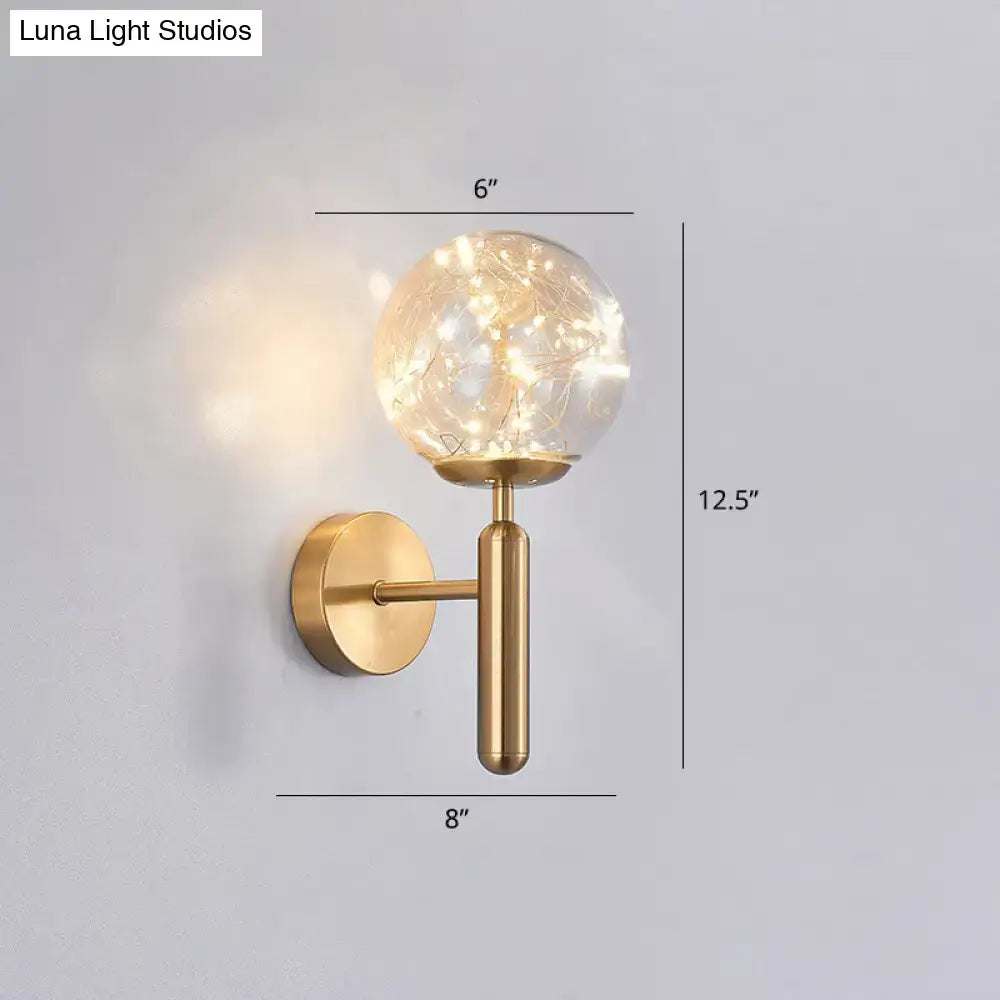 Gold-toned postmodern wall sconce with prismatic glass shade and delicate string lights for modern bedroom lighting