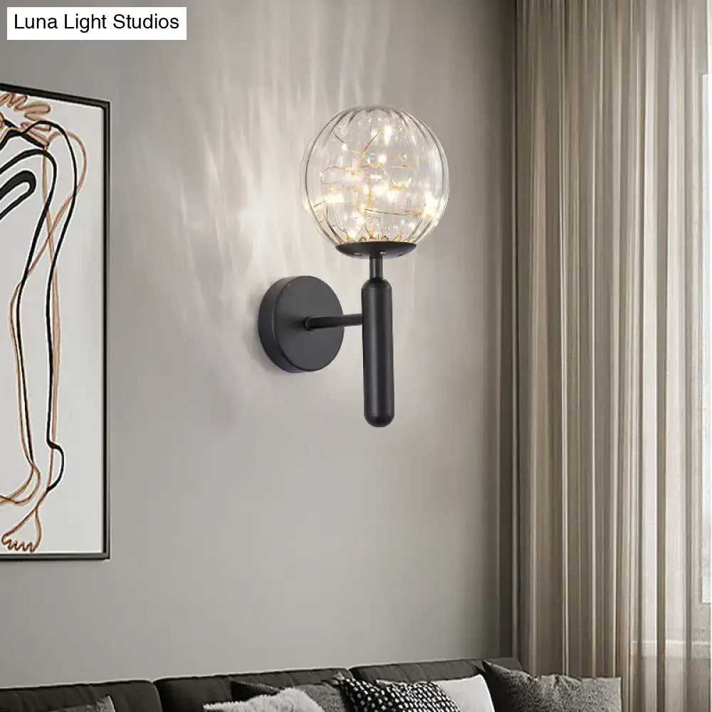 Postmodern black metal wall sconce with spherical glass shade housing warm led lights for modern style bedroom lighting