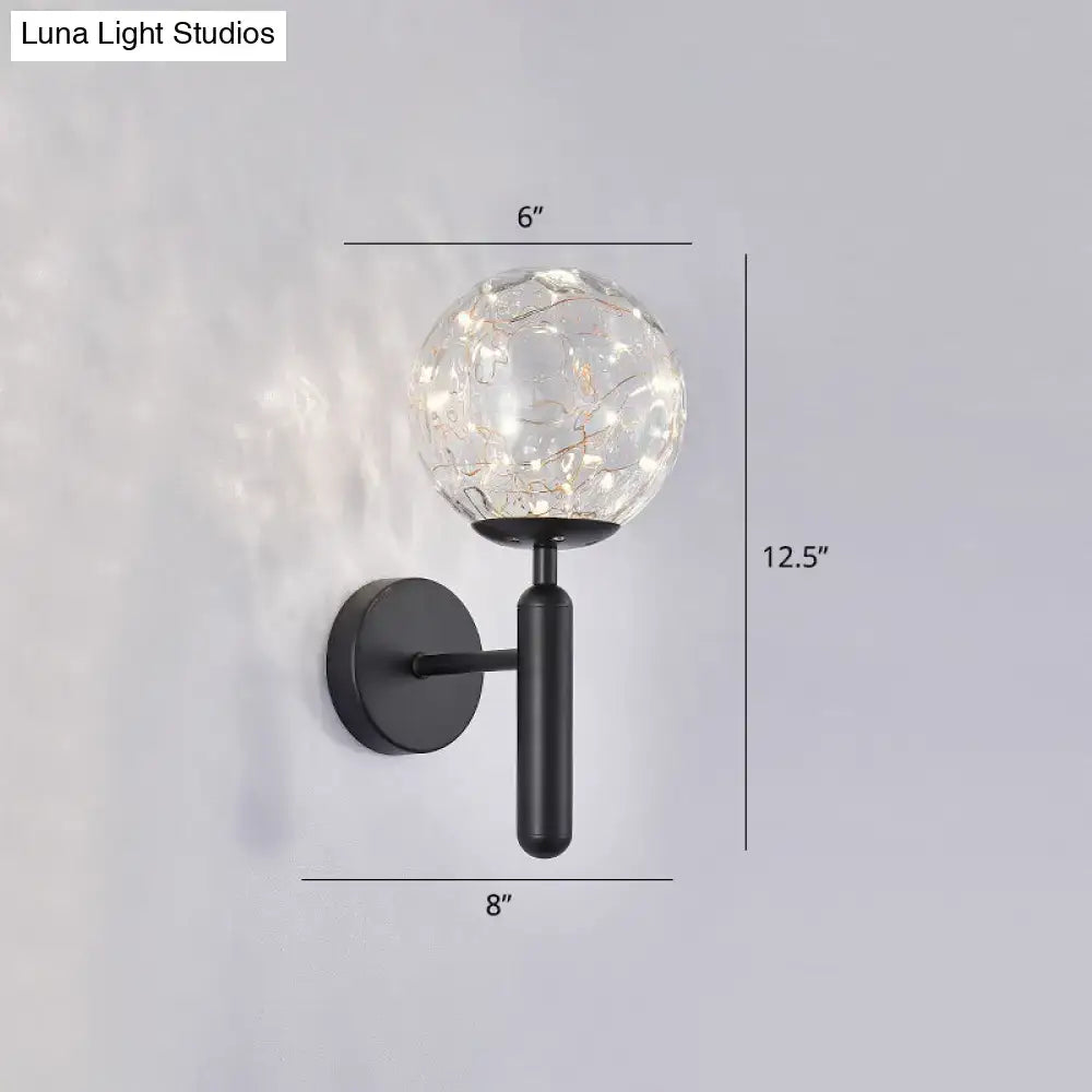 Postmodern black metal wall sconce with crackled prismatic glass shade and warm led fairy lights in modern style