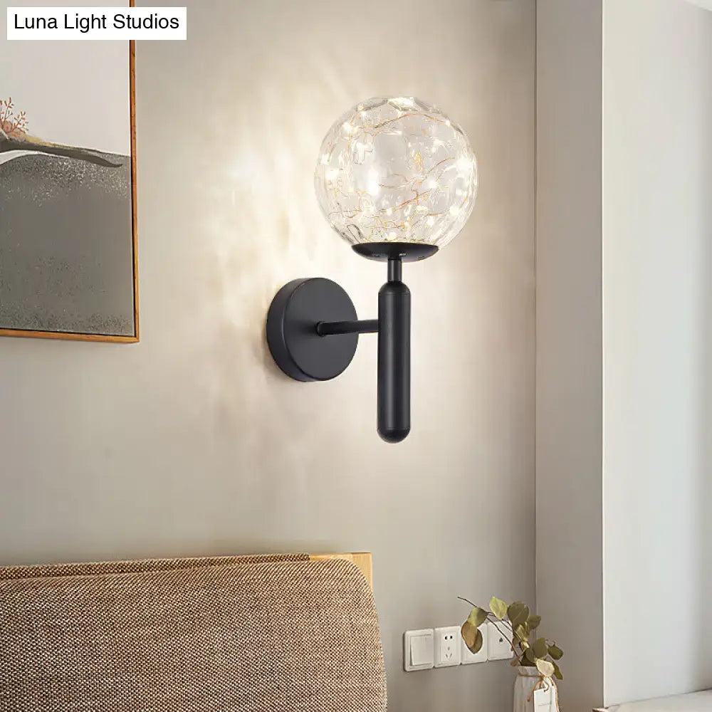 Postmodern black metal wall sconce with a prismatic glass shade and warm led fairy lights in modern style