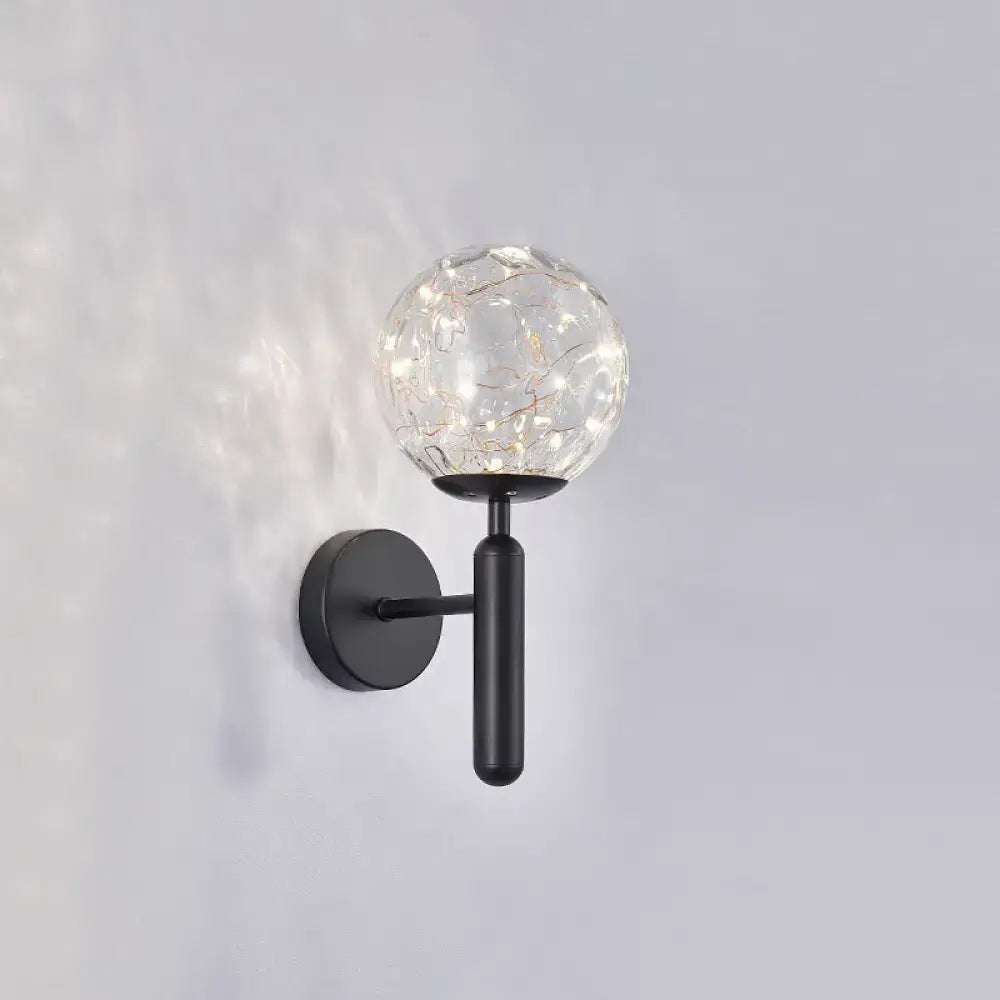 Postmodern black metal wall sconce with crackled prismatic glass shade housing string lights for modern style bedroom lighting
