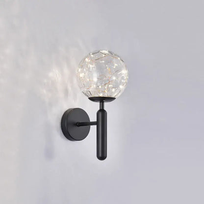 Postmodern black metal wall sconce with crackled prismatic glass shade housing string lights for modern style bedroom lighting