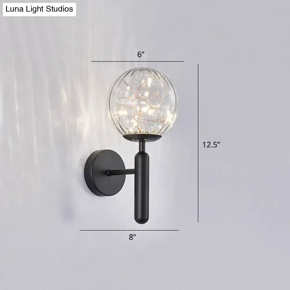 Postmodern black metal wall sconce with a prismatic glass shade and warm led lights for modern style bedroom lighting