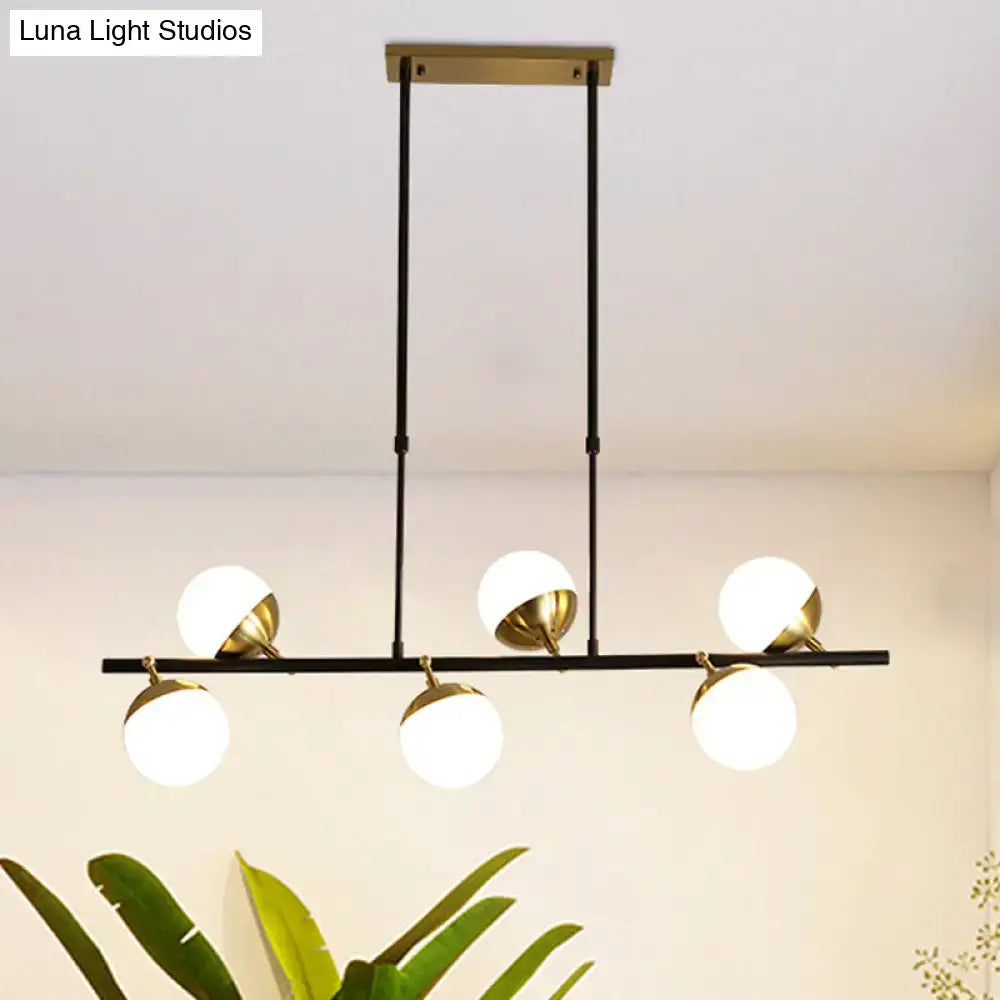 Postmodern black and gold island ceiling light featuring five spherical glass globe shades in brass and black finish