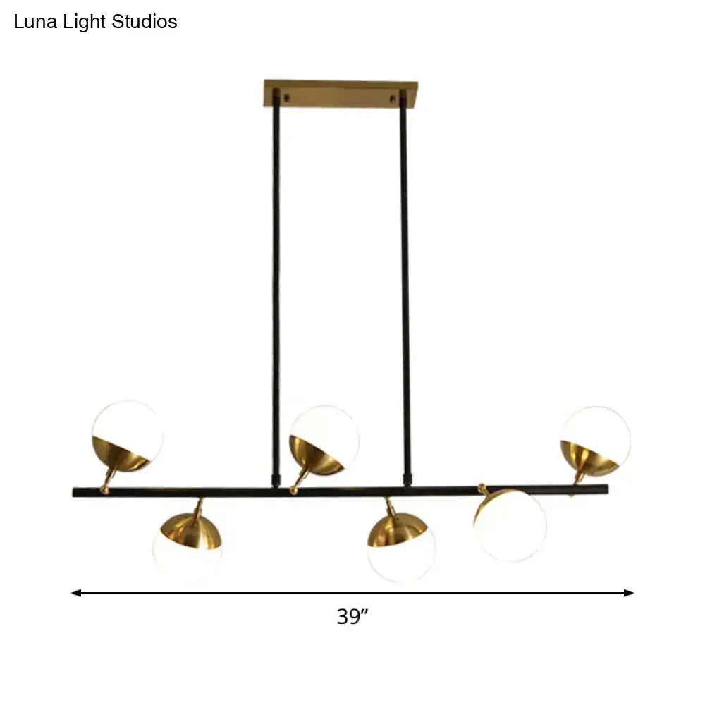 Modern black and brass pendant ceiling light with five spherical glass shades for kitchen island ceiling light use