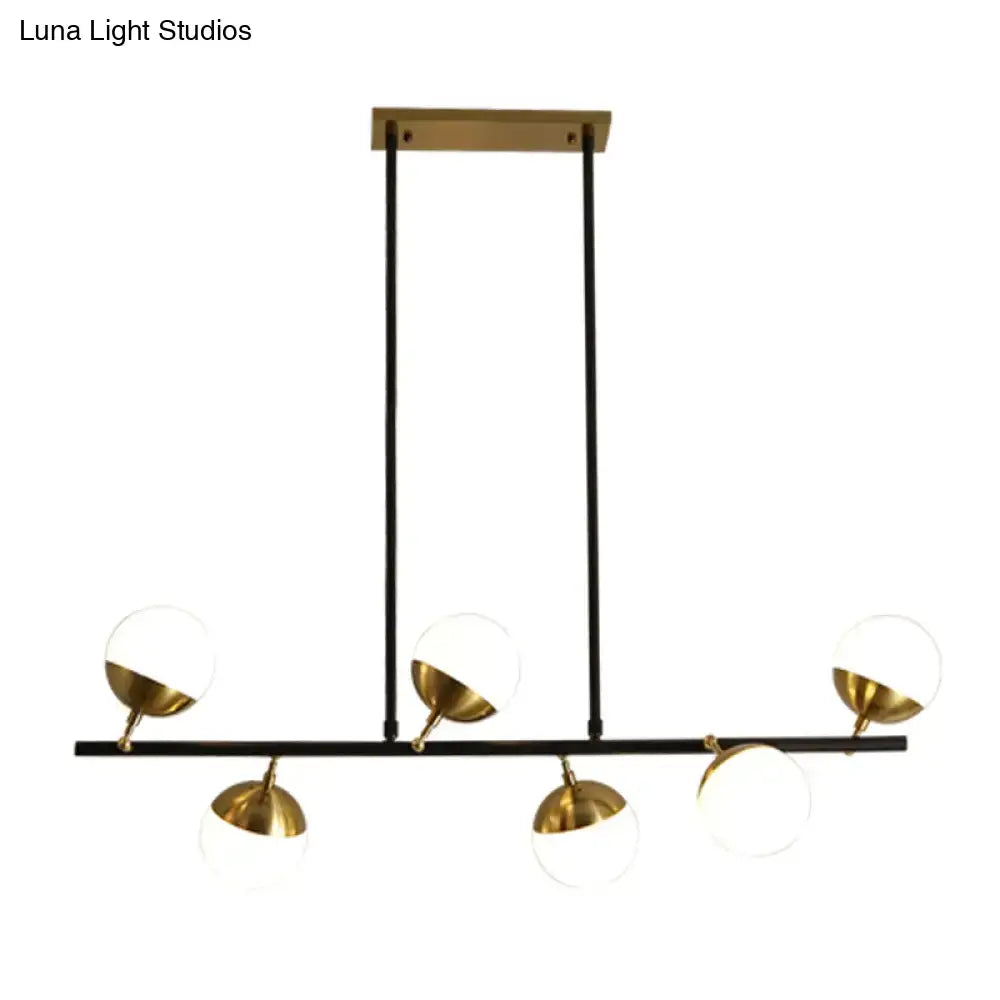 Modern black and gold island ceiling light with spherical glass shades for kitchen pendant lighting