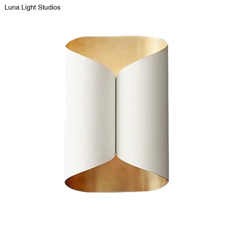 Modern wall lamp with sleek curved white exterior and gold-toned interior lining for stairwell lighting
