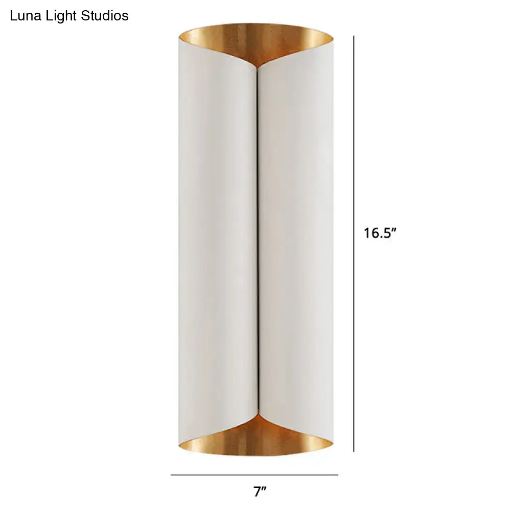 A sleek postmodern wall lamp with white cylindrical body and gold metal accents for stairwell lighting