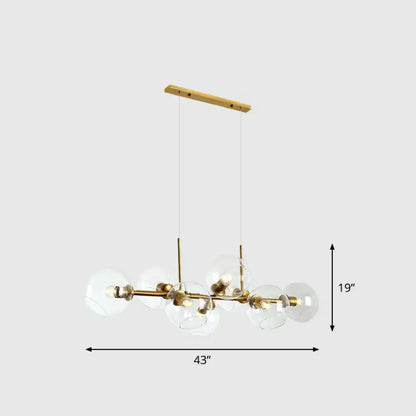 Modern brass and glass chandelier with wooden ceiling mount featuring clear smoke grey glass for dining room lighting type