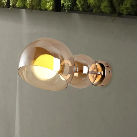 Modern wall lamp bedroom sconce with amber glass shade and brushed brass finish featuring two amber glass globes