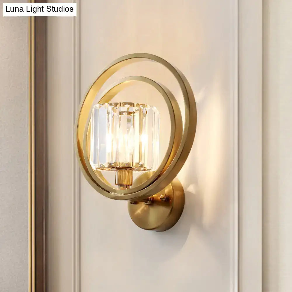 Postmodern gold-toned brass drum wall mount light with circular frame and clear crystal prisms for bedroom sconce