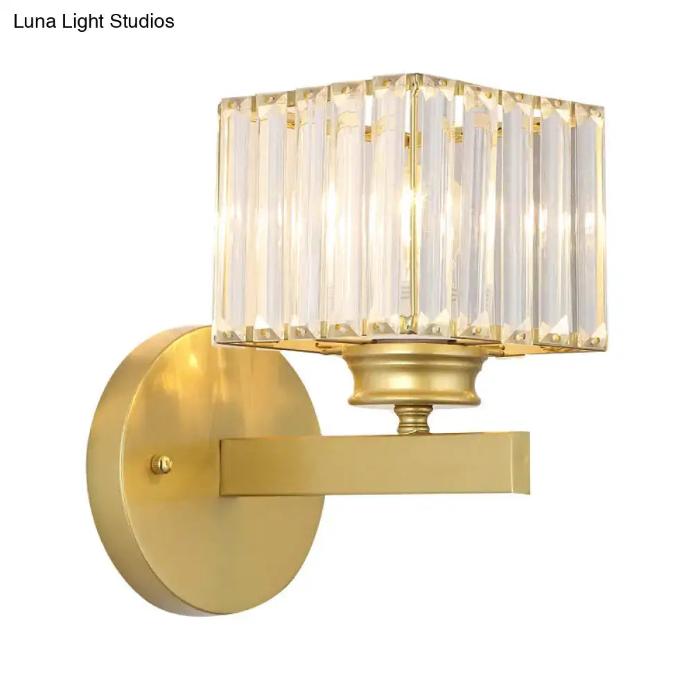 Postmodern gold-finished wall sconce with brass black base and rectangular crystal block shade for bedroom lighting