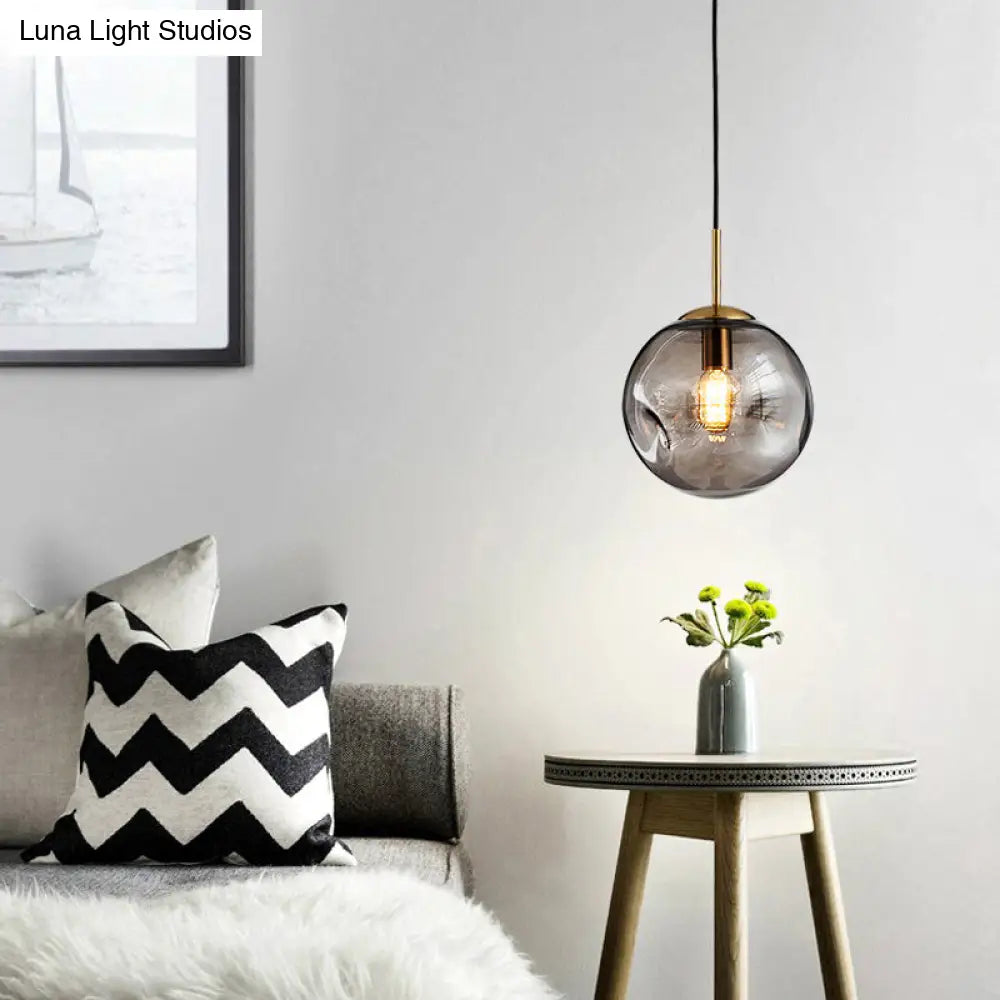 Postmodern Brass Pendant Lamp with Dimpled Glass Globe for Bedroom