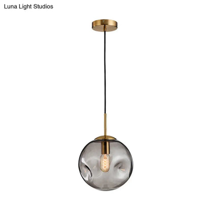 Postmodern Brass Pendant Lamp with Dimpled Glass Globe for Bedroom