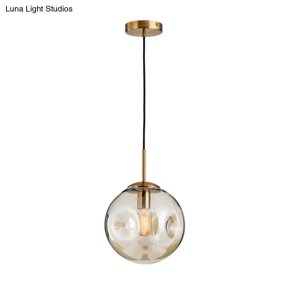 Postmodern Brass Pendant Lamp with Dimpled Glass Globe for Bedroom