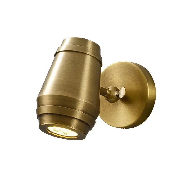 Postmodern brass wall lamp with adjustable cylindrical spotlight and circular base for bedroom decorbites brass wall lamp