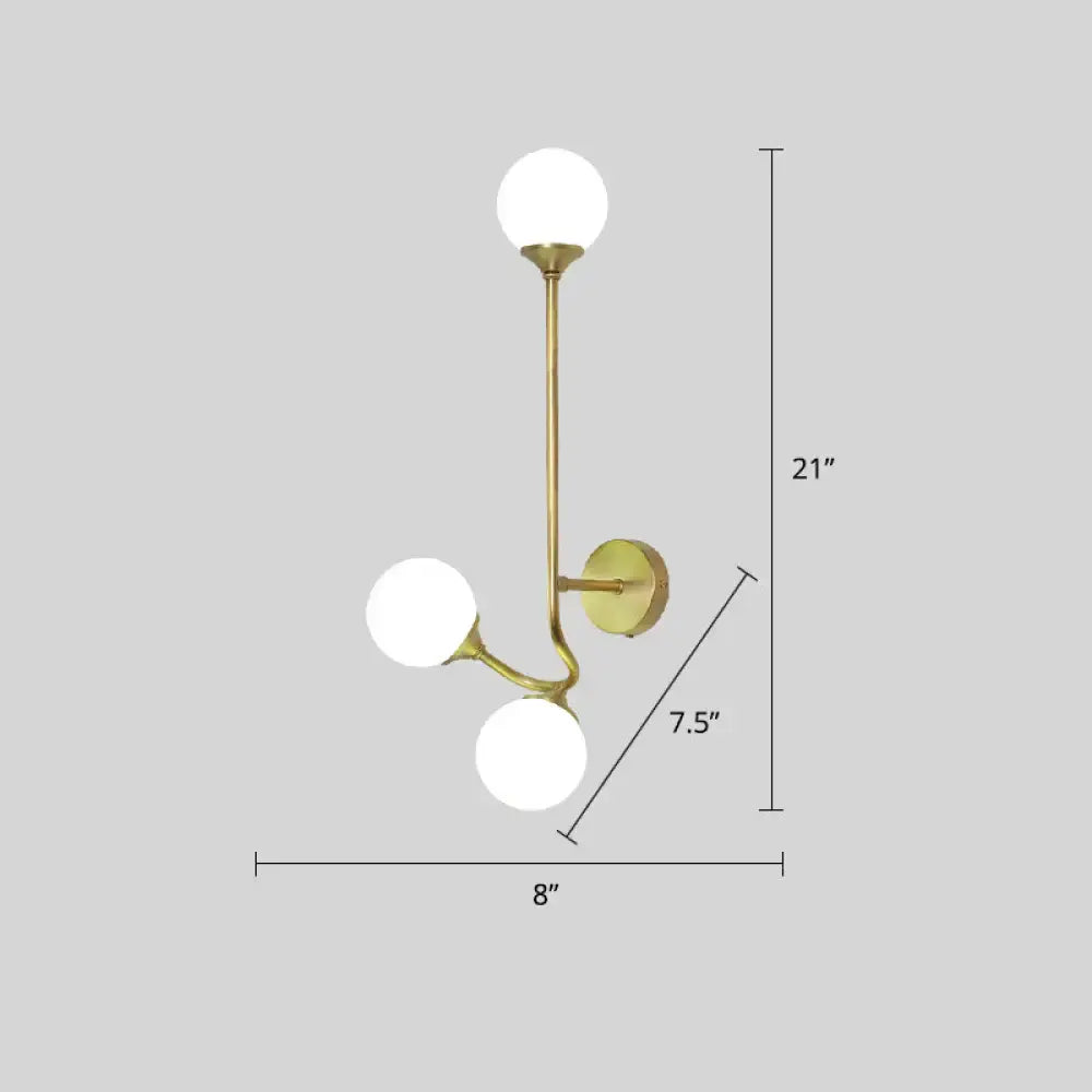 Postmodern brass finished wall sconce with three white glass geometric frosted globe shades for living room use
