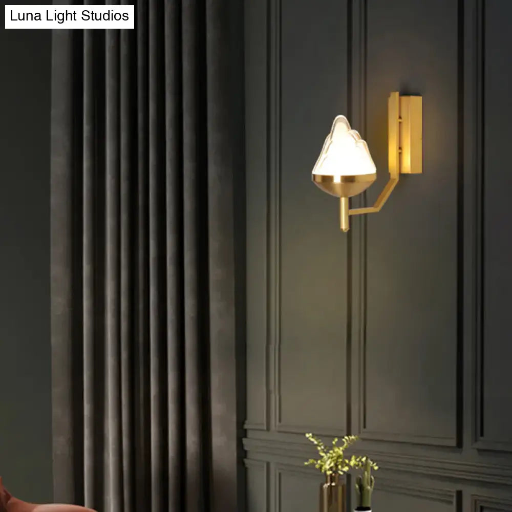 Postmodern brass wall sconce with white glass geometric frosted lampshade shaped like an abstract flame for living room