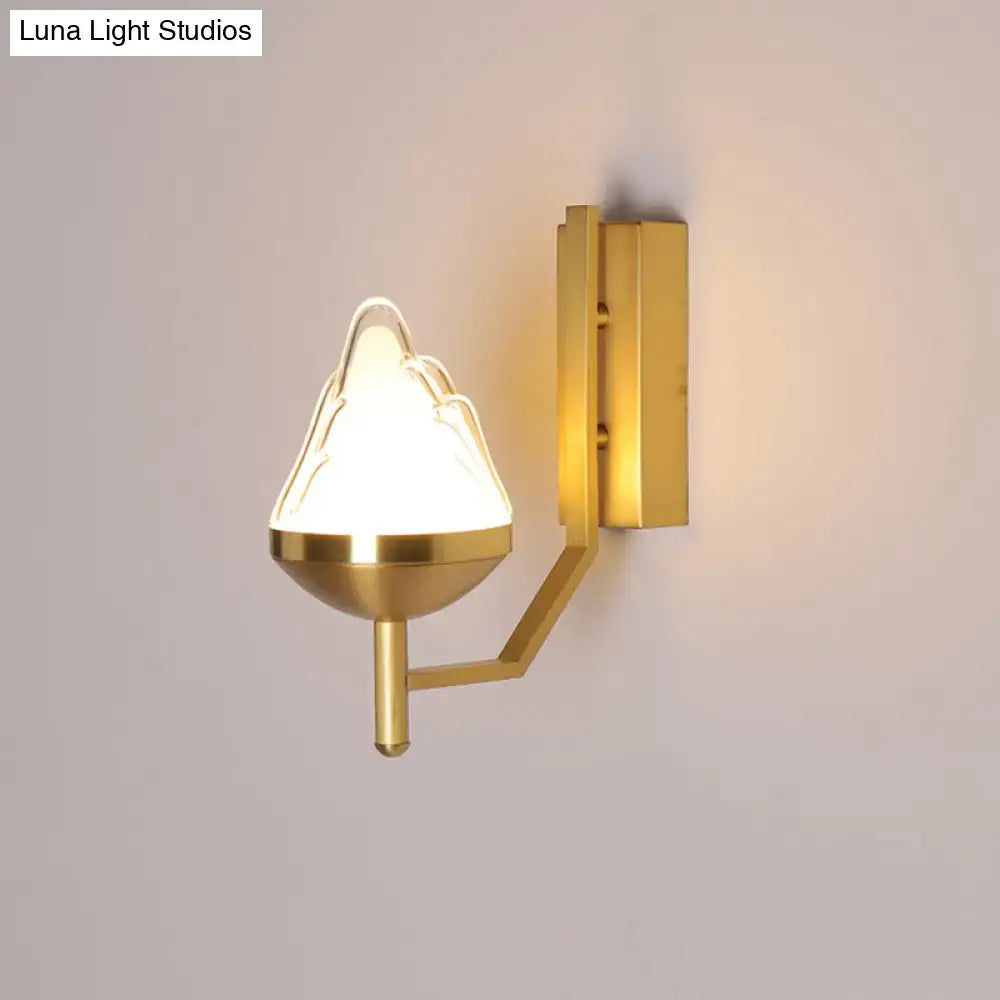 Postmodern brass wall sconce with white glass geometric frosted shade shaped like an inverted mountain peak for living room