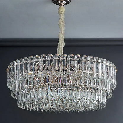 Postmodern decorbites crystal chandelier with clear faceted prisms and teardrop crystals in polished chrome fixture