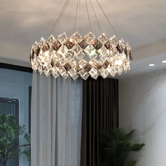 A modern decorbites crystal chandelier with clear and smoky faceted glass in overlapping diamond patterns for living rooms