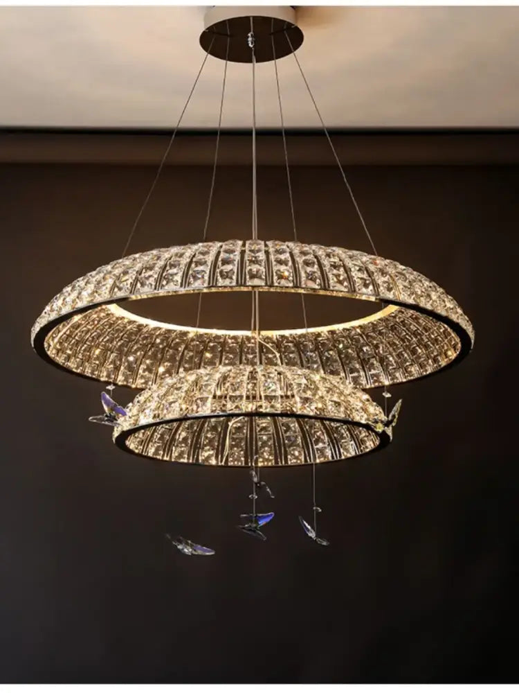 A modern double-tiered postmodern crystal butterfly pendant light chandelier with crystal-encrusted rings for living room decorbites