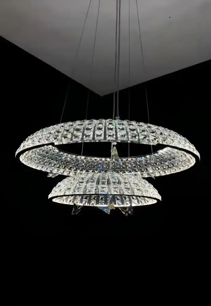 A modern multi-tiered chrome pendant light with cascading faceted glass in decorbites crystal butterfly style