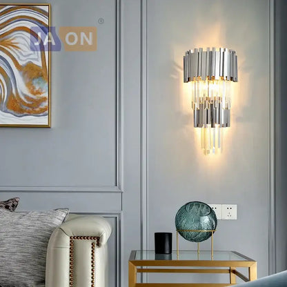 Modern chrome-finished wall sconce with cascading crystal rods emitting warm glow decorbites crystal golden led light