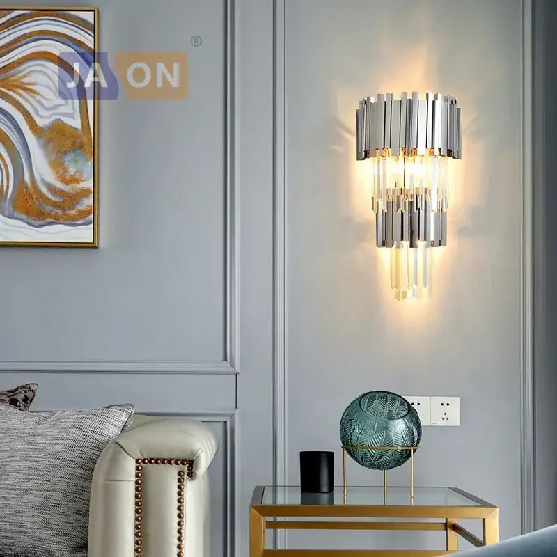 Modern chrome-finished wall sconce with cascading crystal rods emitting warm glow decorbites crystal golden led light