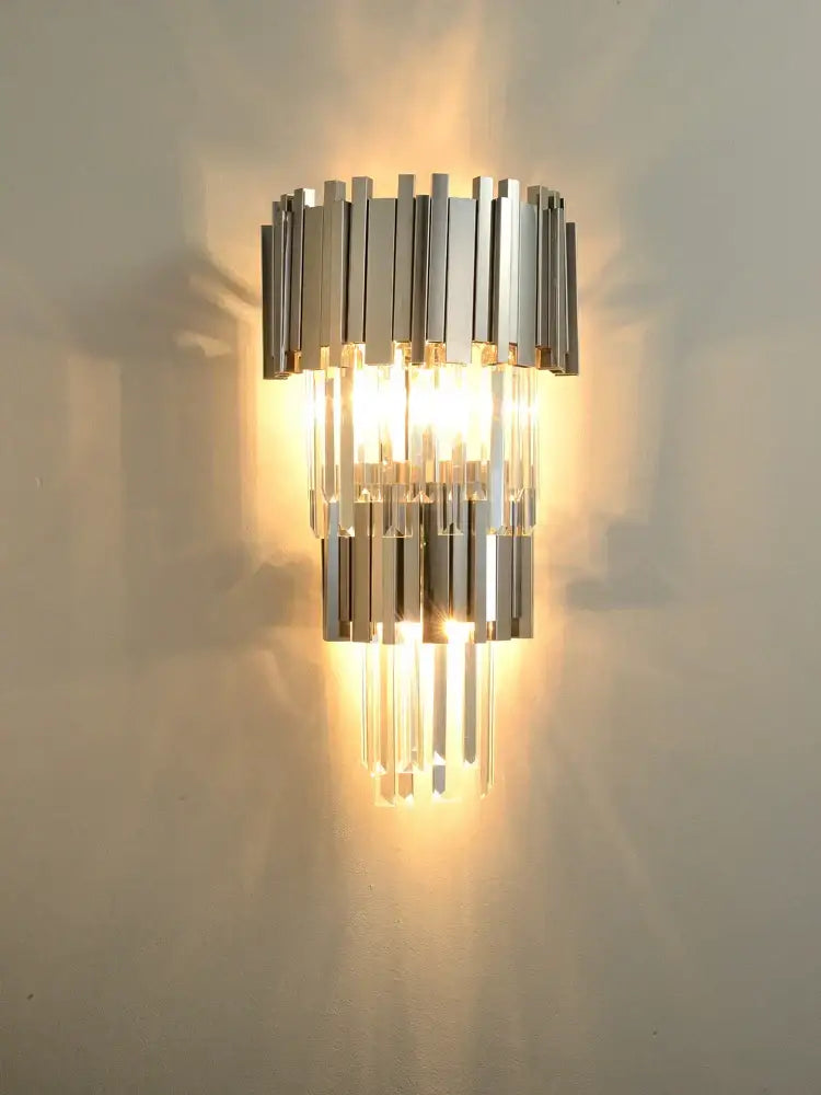 Postmodern crystal golden led wall sconce with chrome and crystal tiered vertical bars casting warm light by decorbites crystal golden