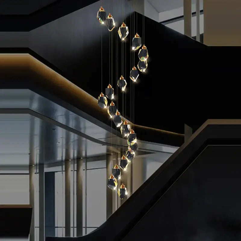 A modern postmodern crystal stone copper cascading chandelier with faceted crystal pendants and gold-toned fixtures for staircase lighting