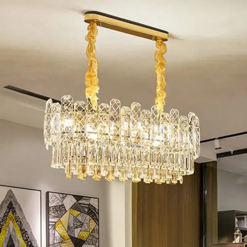A modern decorbites gold lustre chandelier with gold-toned metal and cascading clear glass prisms for dining rooms