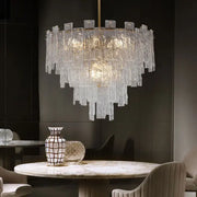 A modern decorbites crystal chandelier with frosted glass rods in concentric tiers for dining room lighting