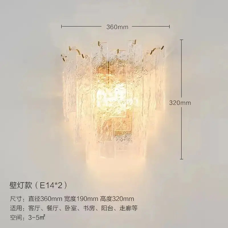 A warm glowing wall-mounted lamp with textured frosted glass and gold accents in decorbites crystal chandelier style